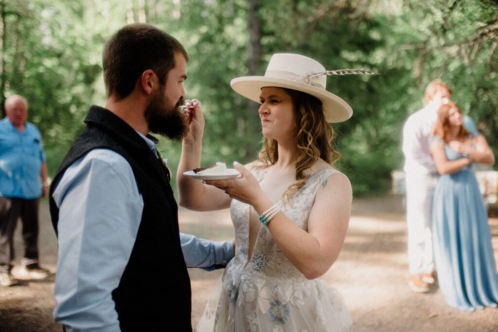 How to have a micro wedding in Glacier National Park with 30 friends and family. Couple and wedding guests in front of trees in celebration.