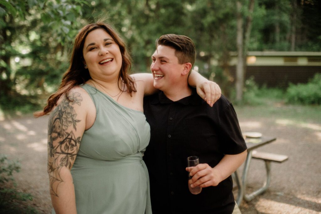 How to have a micro wedding in Glacier National Park with 30 friends and family. Couple and wedding guests in front of trees in celebration.