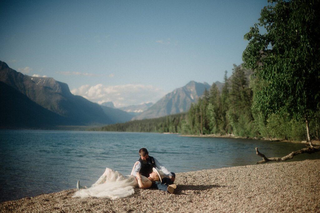 How to have a micro wedding in Glacier National Park with 30 friends and family. Bride laying on Groom's lap.