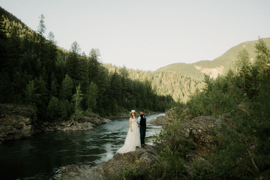 How to have a micro wedding in Glacier National Park, Couple standing next to Sprout Creek.