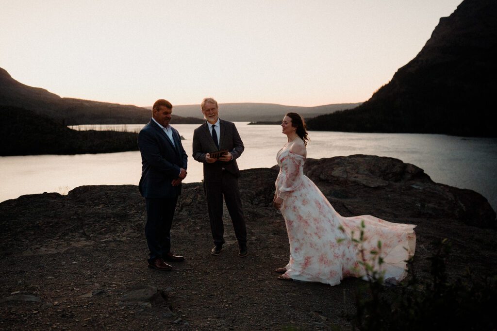 Sunrise wedding ceremony at Glacier National Park at Sun Point. 