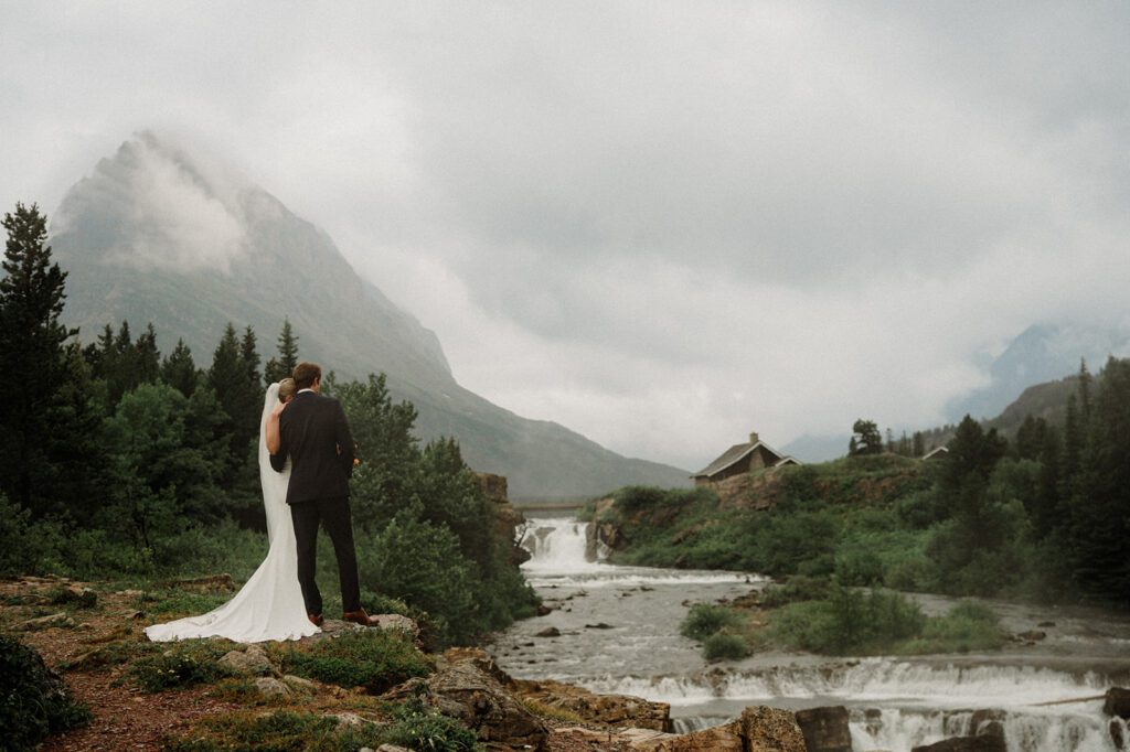This rain filled National Park wedding in Glacier what dreams are made of! Includes tunnel photos, Going-to-the-Sun road, and Many Glacier hotel ceremony. 