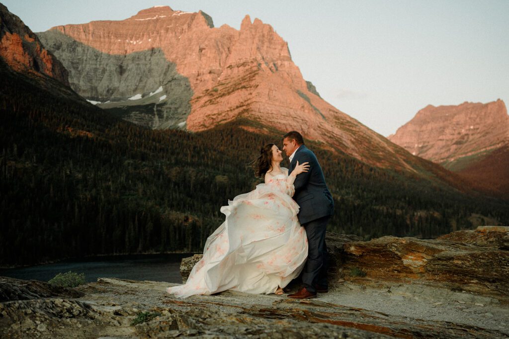 Sun Point Micro Wedding sunrise photo of bride and groom kissing with water behind them.