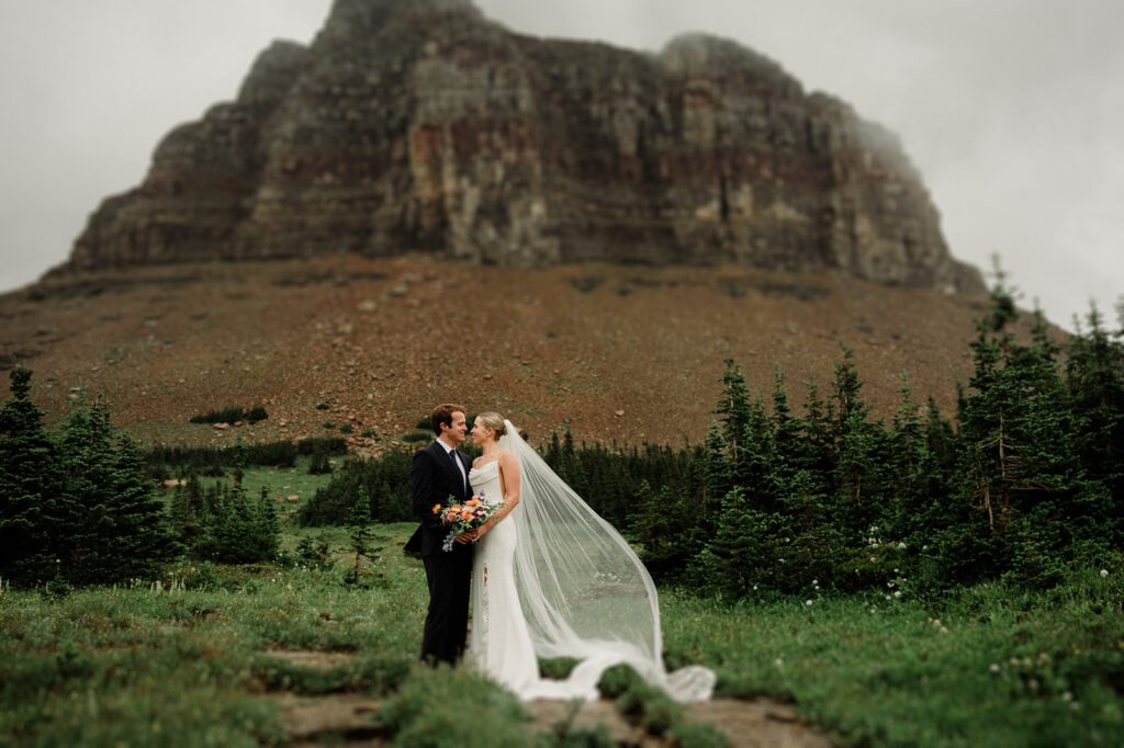 This rain filled National Park wedding in Glacier what dreams are made of! Includes tunnel photos, Going-to-the-Sun road, and Many Glacier hotel ceremony. 