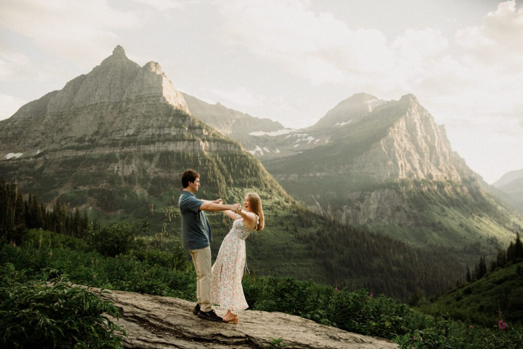 Man and woman during their Glacier National Park engagement session! They romped around the amazing Going-to-the-Sun Road, and some of the highlights are in Logan Pass! The best of 2025 Elopement & Wedding Photography.
