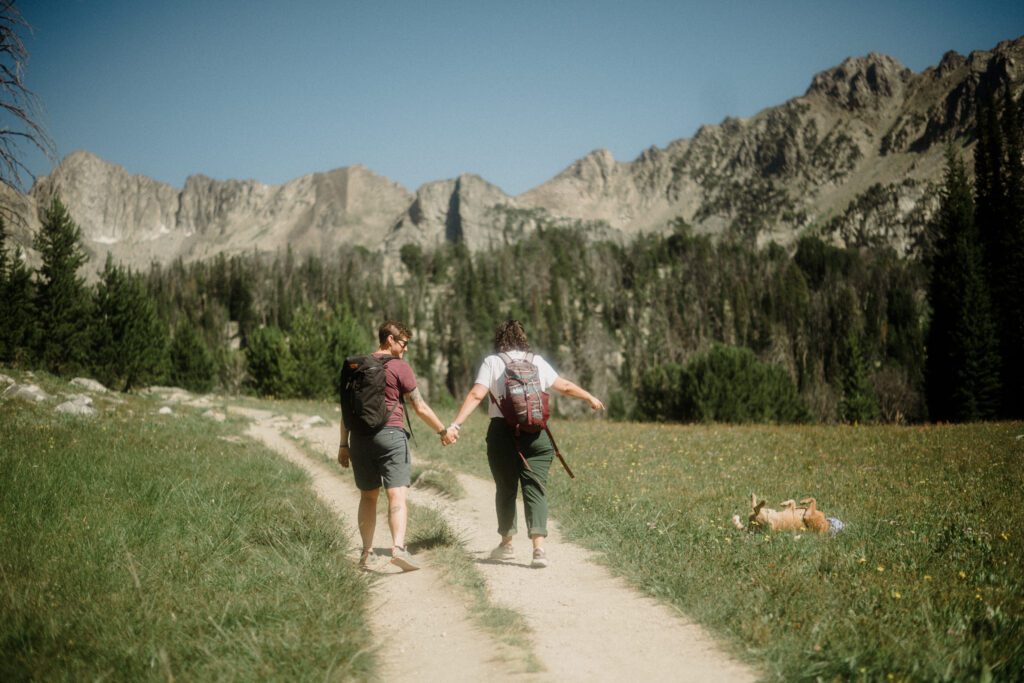 K&S's Montana hiking engagement session in Big Sky —wildflowers, adventure vibes, and pup cameos included!