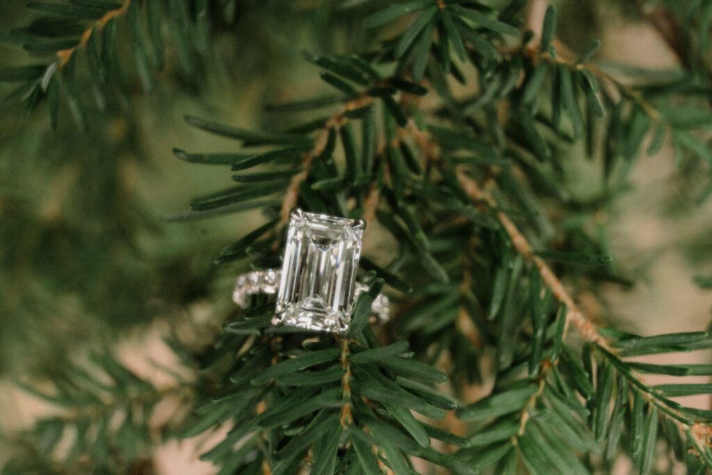 Emerald-cut diamond engagement ring sparkling in the Montana sun