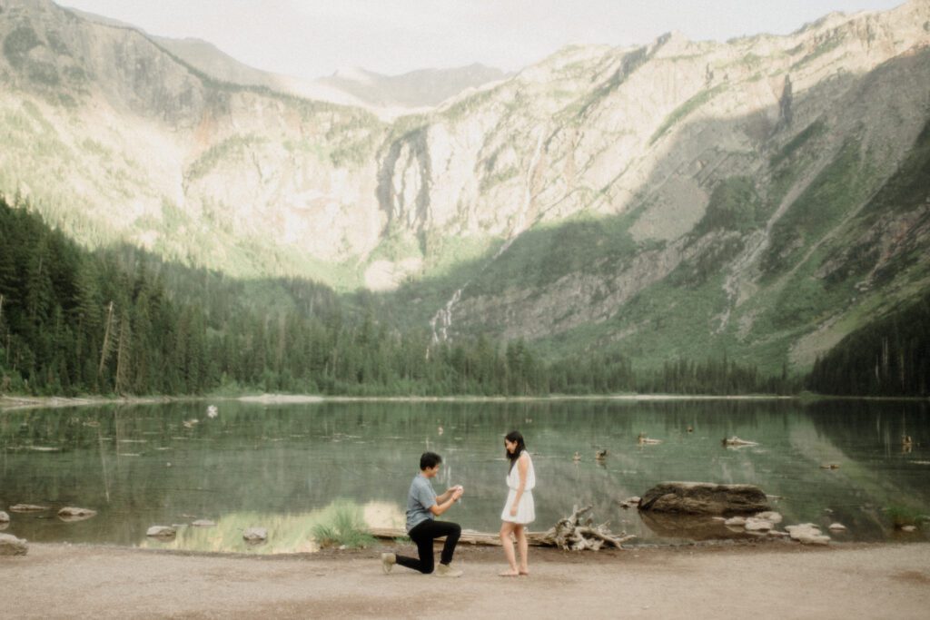 Romantic hiking proposal with mountain views and alpine lake backdrop
