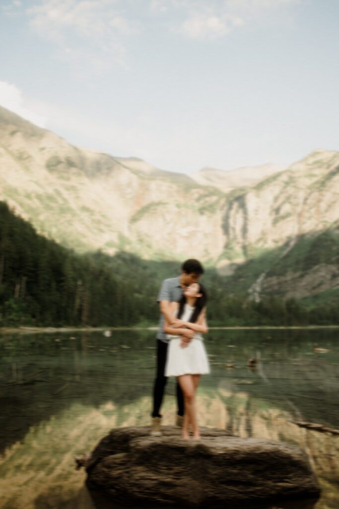 Surprised bride-to-be smiling during emotional hiking proposal in Glacier National Park