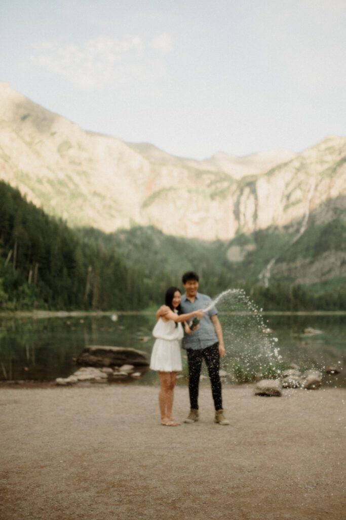 Romantic hiking proposal with mountain views and alpine lake backdrop