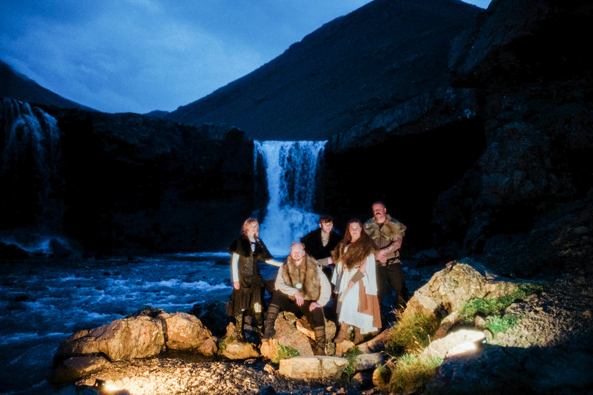 An epic Viking elopement in Vestrahorn Iceland. Photo in front of blue waterfall.