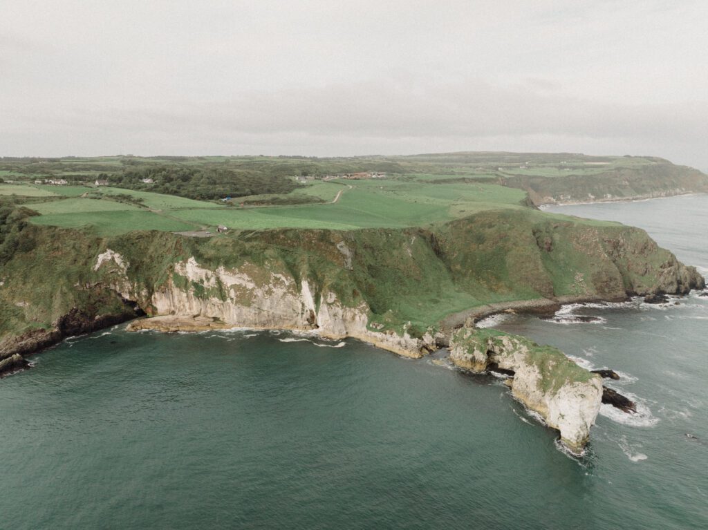 Northern Ireland elopement with epic locations like Kinbane Castle, Ballintoy Harbor and Giant's Causeway! LGBTQ+ wedding photographer takes Debbie & Kirstie on an epic adventure in Northern Ireland!