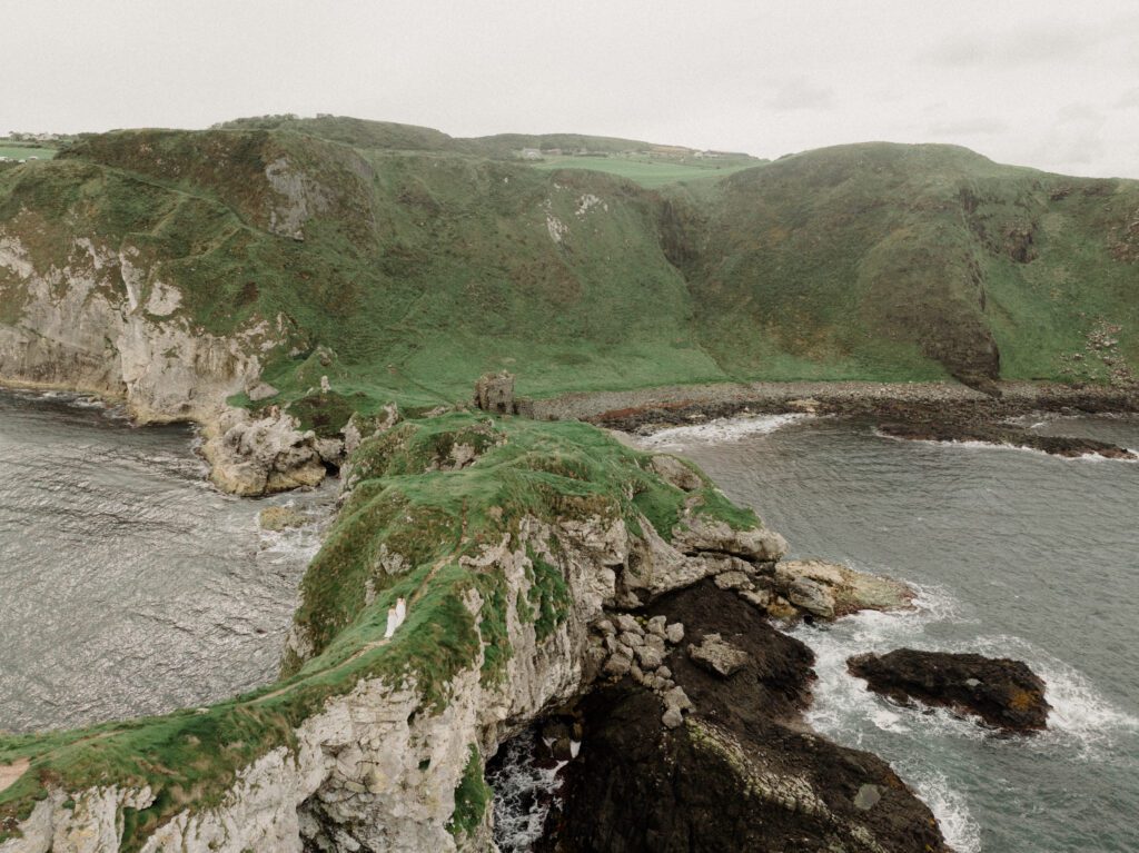 Northern Ireland elopement with epic locations like Kinbane Castle, Ballintoy Harbor and Giant's Causeway! LGBTQ+ wedding photographer takes Debbie & Kirstie on an epic adventure in Northern Ireland!