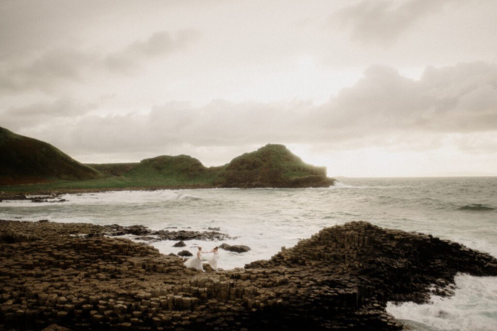 Northern Ireland elopement with epic locations like Kinbane Castle, Ballintoy Harbor and Giant's Causeway! LGBTQ+ wedding photographer takes Debbie & Kirstie on an epic adventure in Northern Ireland!