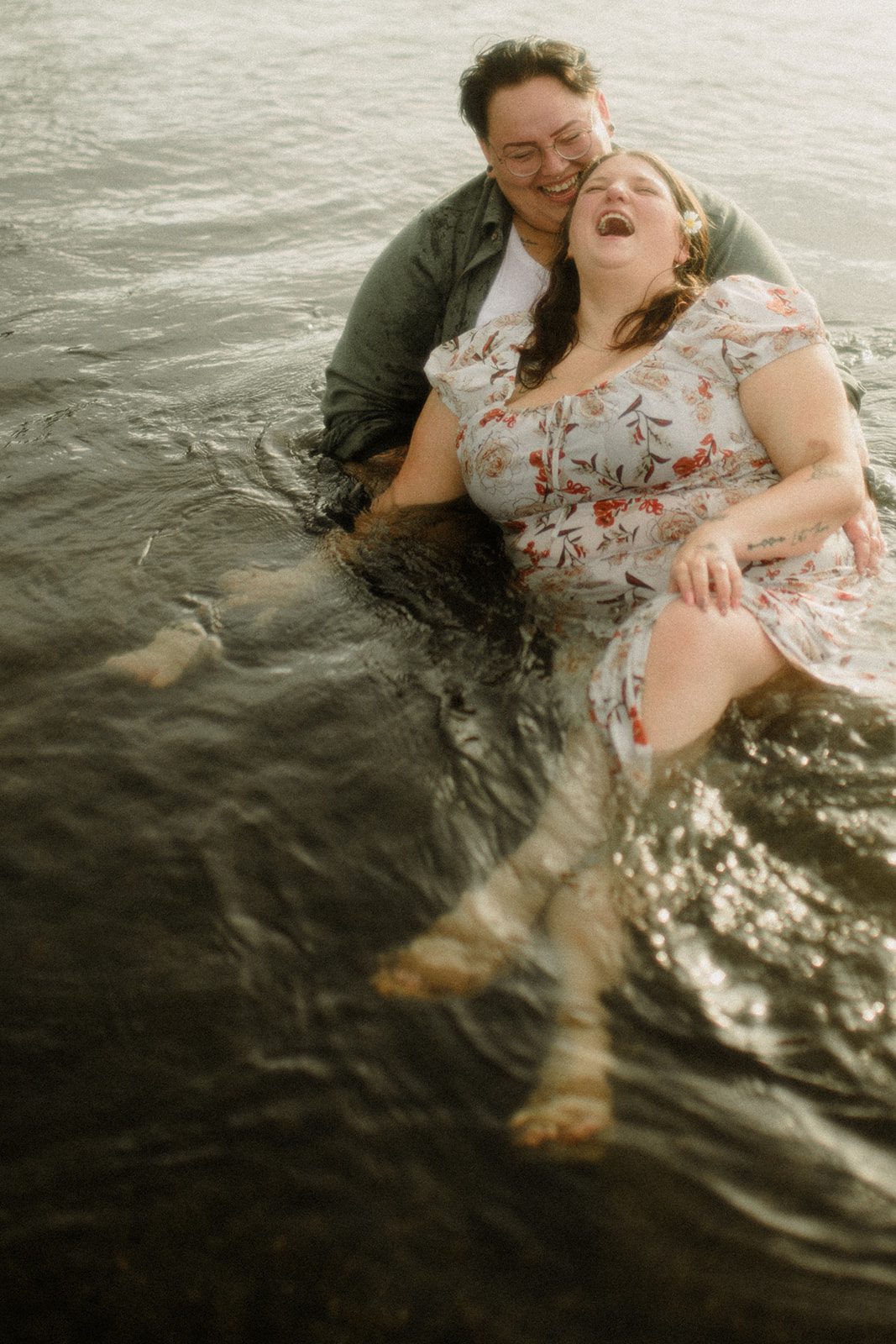 Yellowstone National Park picnic proposal. Lesbian couple playing in the water.