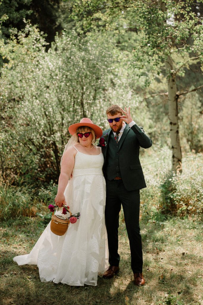 A fun non-traditional wedding in Bozeman with flower baskets, pizza, a “gaggle” wedding party, and sunset photos. See how this couple rewrote the rules.