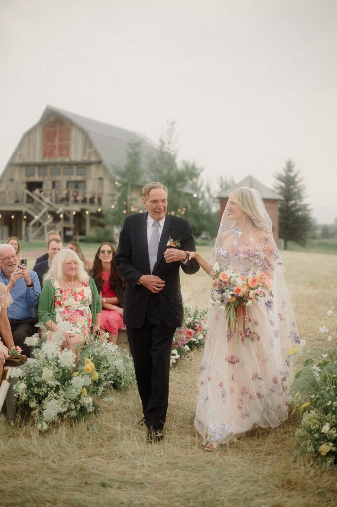 Colorful modern wedding in Bozeman at Firelight Farm featuring vibrant fashion, Filipino desserts, sunset portraits, and a disco after party.