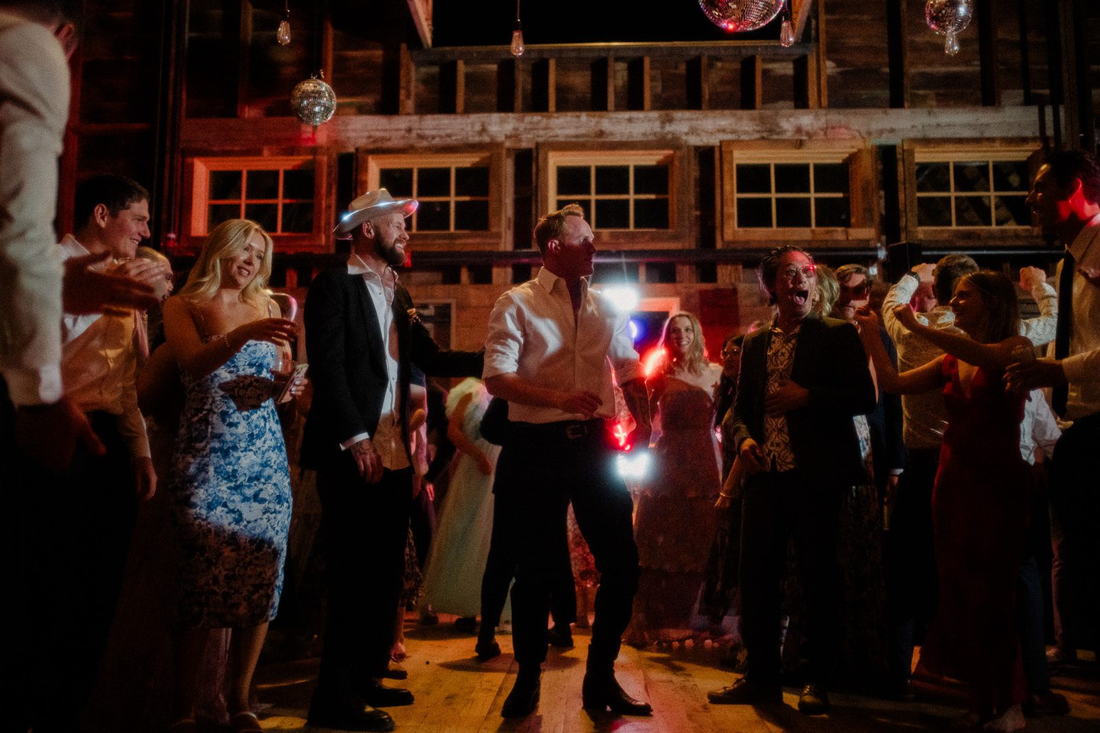 Colorful modern wedding in Bozeman at Firelight Farm featuring vibrant fashion, Filipino desserts, sunset portraits, and a disco after party.