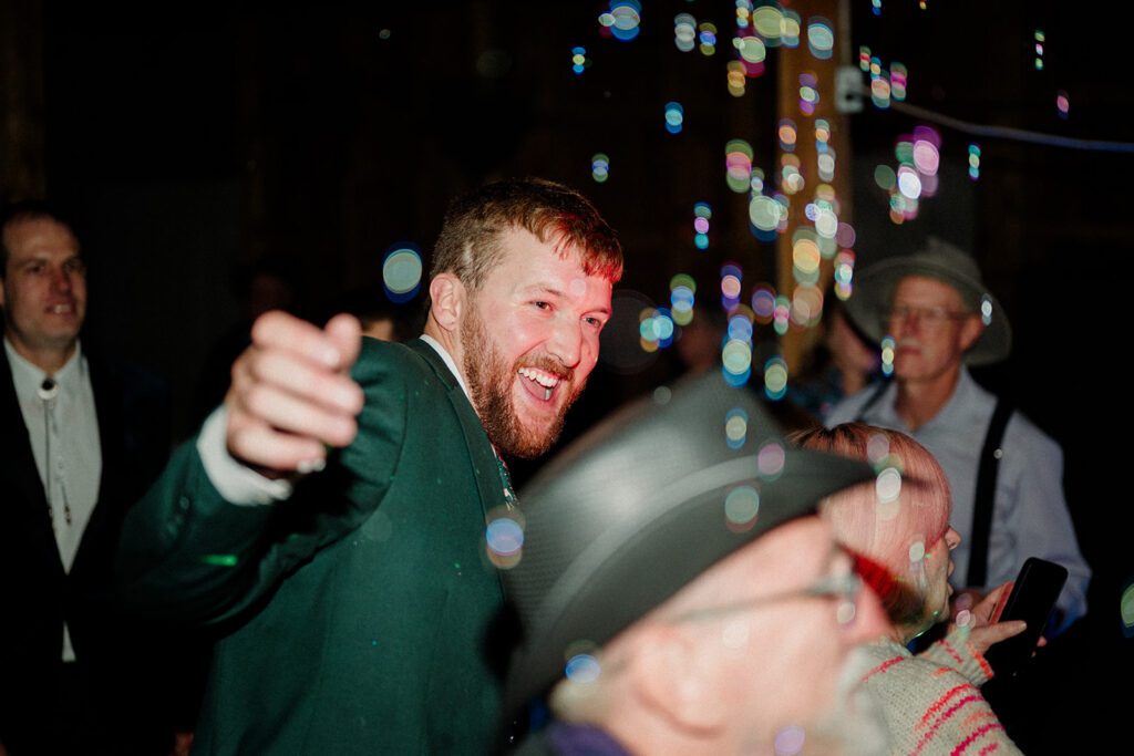 A fun non-traditional wedding in Bozeman with flower baskets, pizza, a “gaggle” wedding party, and sunset photos. See how this couple rewrote the rules.