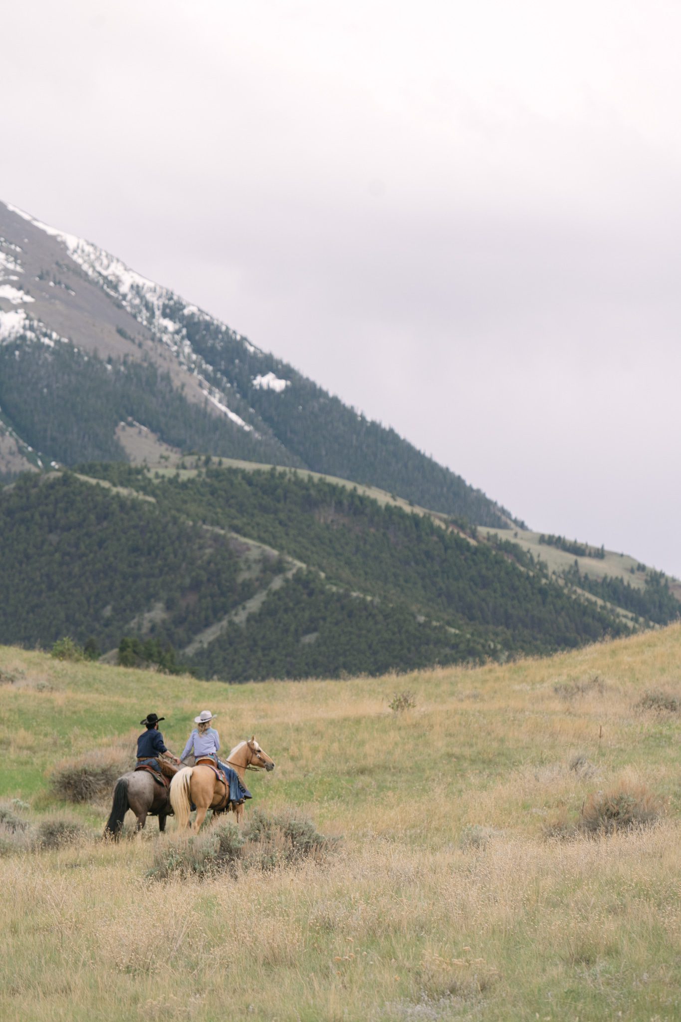 Adventure couple session riding horses at Chico Hot Springs, Montana in Paradise Valley