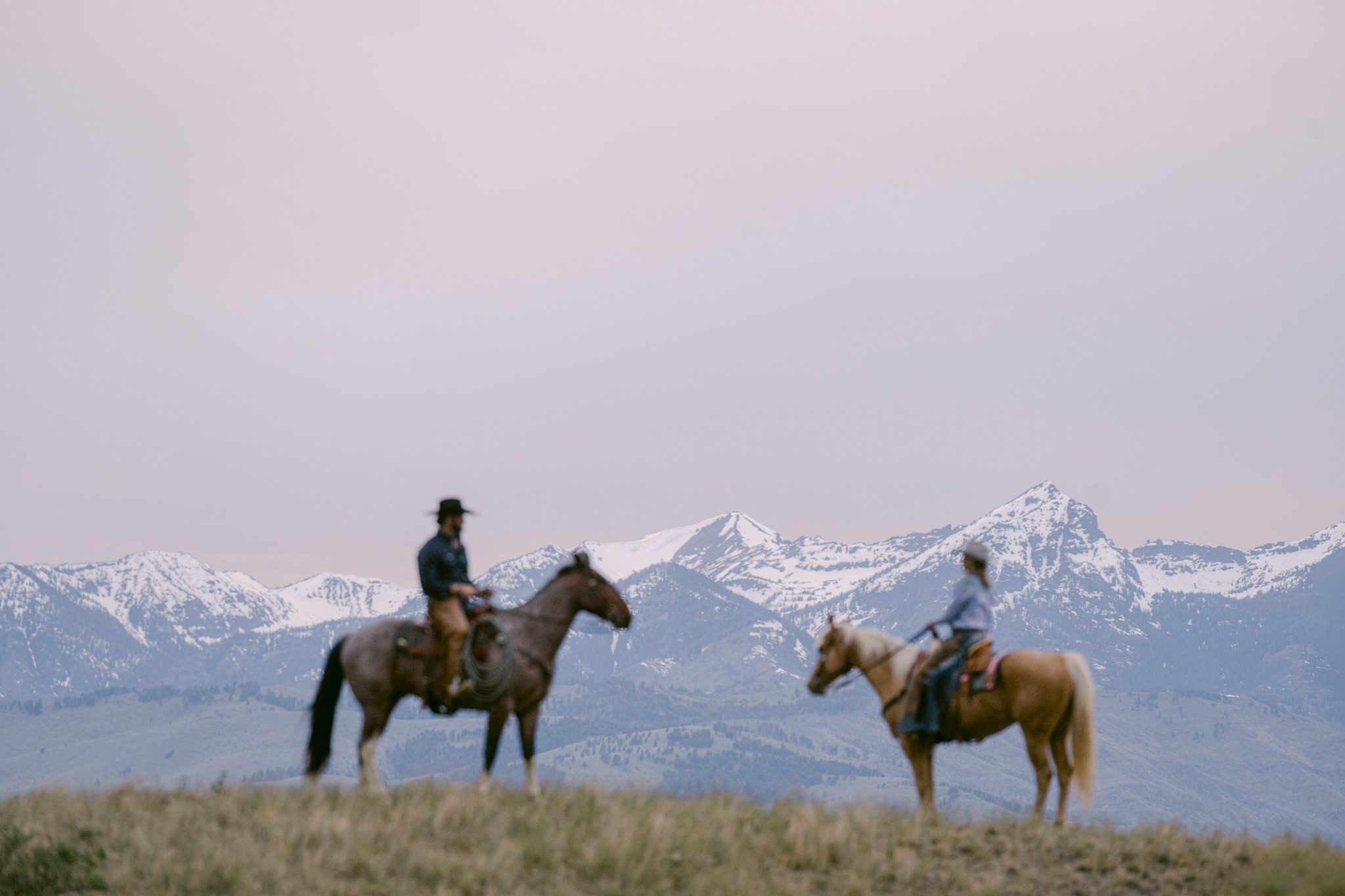 Adventure couple session riding horses at Chico Hot Springs, Montana in Paradise Valley