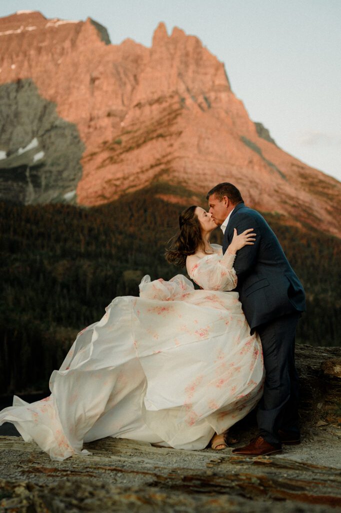 A couple renews their vows during sunrise in Glacier National Park. Vow renewal in Glacier National Park.